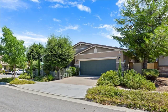 a front view of a house with a yard garage and outdoor seating