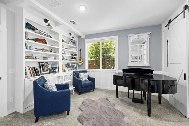 a bedroom with a bed a couch and a window