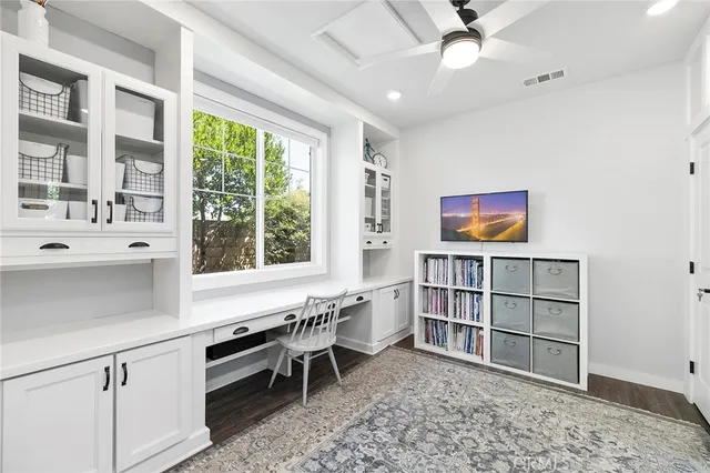 a bedroom with a large bed and a wooden floor