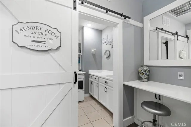 a bathroom with a tub a double vanity sink and mirrors