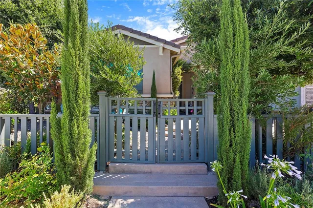 a view of a chair and table under an umbrella in the patio