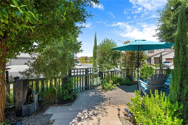 a view of a chairs and table in a backyard