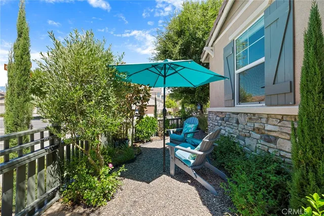 a view of a patio with couches under an umbrella