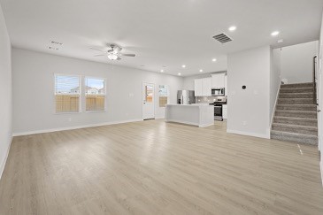 7906 Alset Magnolia, TX 77354 - Photo 2 of 11 an empty room with wooden floor and windows
