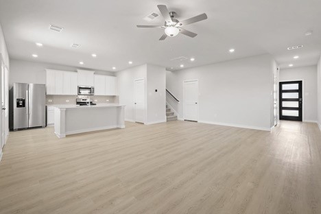 7906 Alset Magnolia, TX 77354 - Photo 3 of 11 a view of a kitchen with a stove cabinets and wooden floor