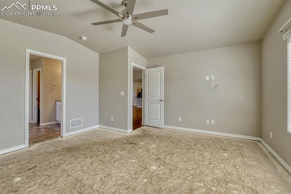 8437 Salt Brush Road Colorado Springs, CO 80908 - Photo 12 of 45 Envision your dream bedroom in this spacious primary suite, complete with a ceiling fan and vaulted ceiling, where you can add your personal style to the unfinished floors and make it truly yours.