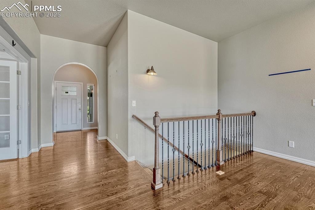 8437 Salt Brush Road Colorado Springs, CO 80908 - Photo 2 of 45 A beautifully designed hallway boasts stunning wood floors and an elegant upstairs landing.