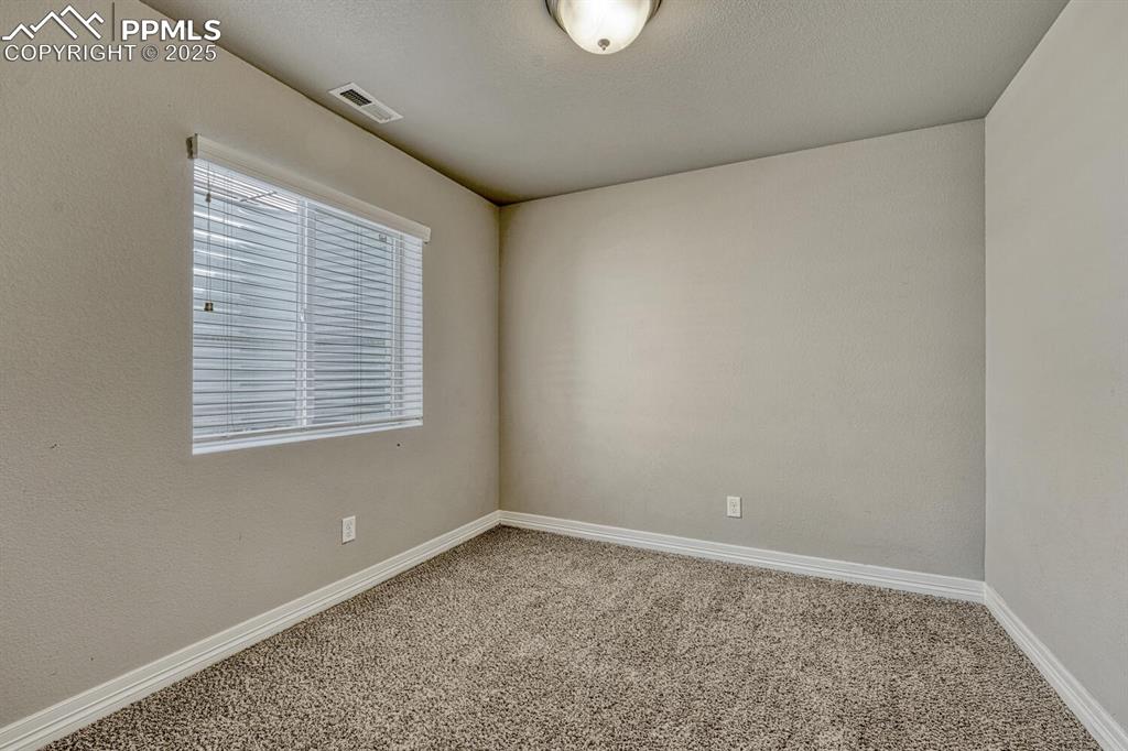 8437 Salt Brush Road Colorado Springs, CO 80908 - Photo 24 of 45 A carpeted spare room with baseboards offers endless possibilities for transformation.