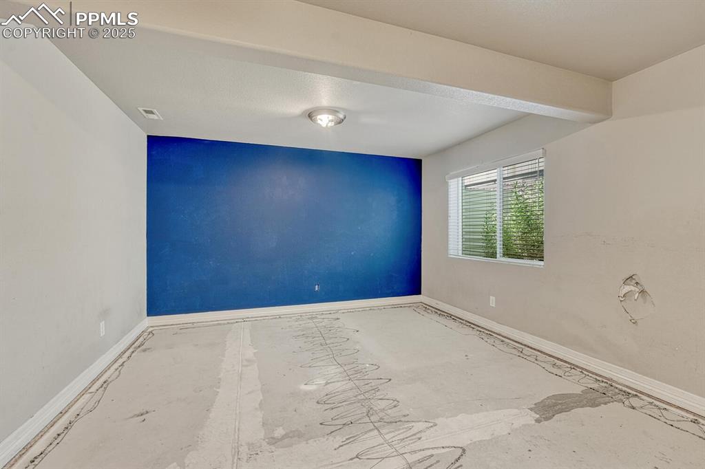 8437 Salt Brush Road Colorado Springs, CO 80908 - Photo 28 of 45 This spare bedroom is ready for your personal touch, featuring baseboards, a spacious walk-in closet, and a textured ceiling.