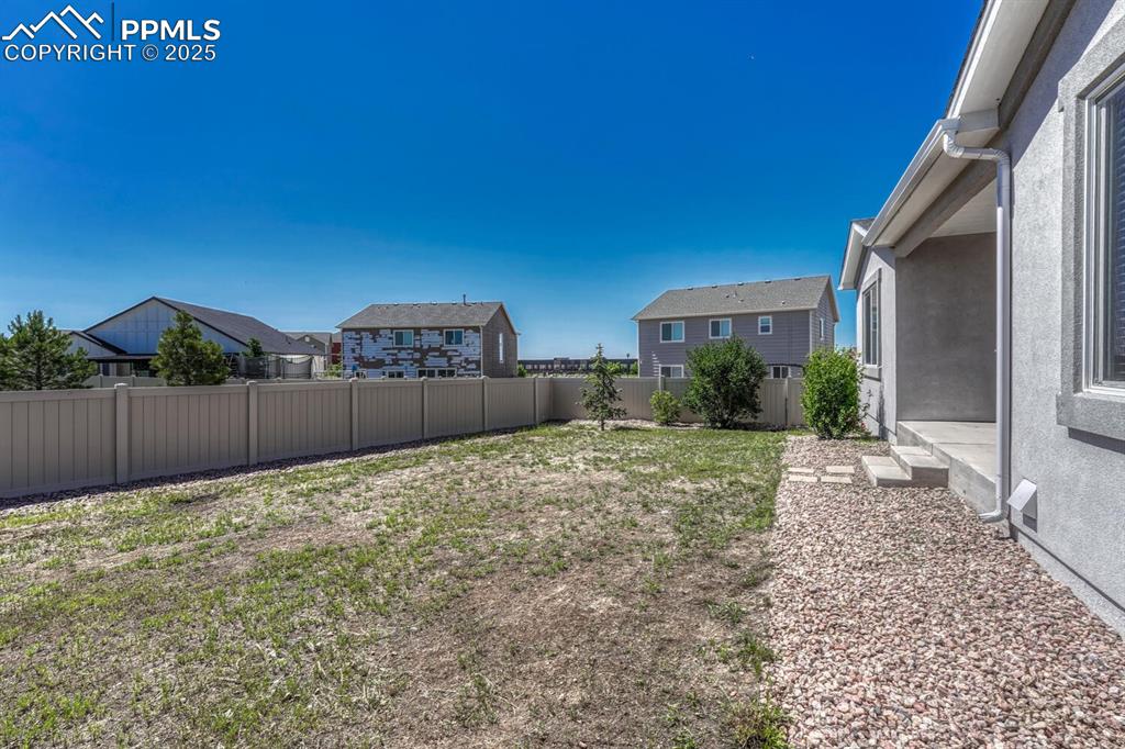 8437 Salt Brush Road Colorado Springs, CO 80908 - Photo 32 of 45 Enjoy the perfect blend of seclusion and scenery in a fenced backyard with a lovely residential view.
