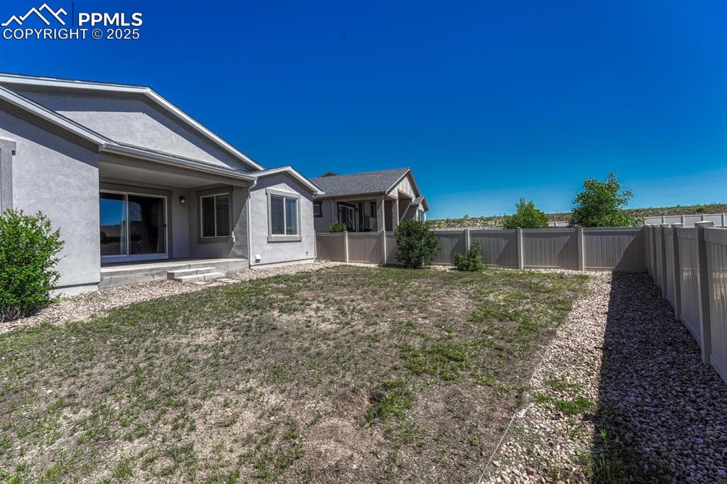 8437 Salt Brush Road Colorado Springs, CO 80908 - Photo 33 of 45 Enjoy the perfect blend of seclusion and scenery in a fenced backyard with a lovely residential view.