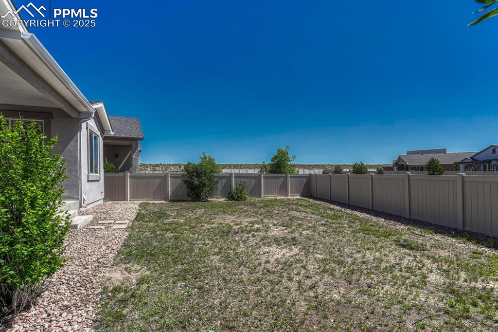 8437 Salt Brush Road Colorado Springs, CO 80908 - Photo 34 of 45 Enjoy the perfect blend of seclusion and scenery in a fenced backyard with a lovely residential view.