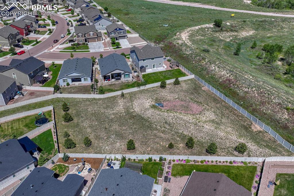 8437 Salt Brush Road Colorado Springs, CO 80908 - Photo 38 of 45 Elevate your perspective with this captivating aerial view, highlighting the property's prime location within a desirable suburban area, full of promise and potential.