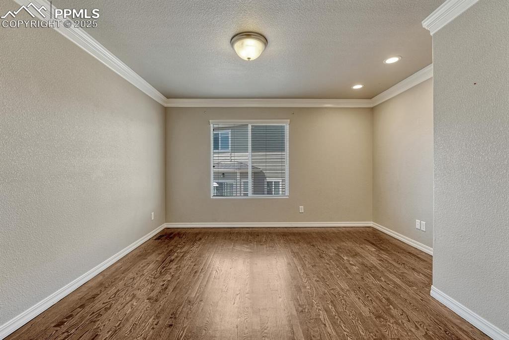 8437 Salt Brush Road Colorado Springs, CO 80908 - Photo 4 of 45 Step into a haven of refinement and efficiency, where french doors, intricate moulding, beautiful wood floors, and subtle recessed lighting create the perfect atmosphere.