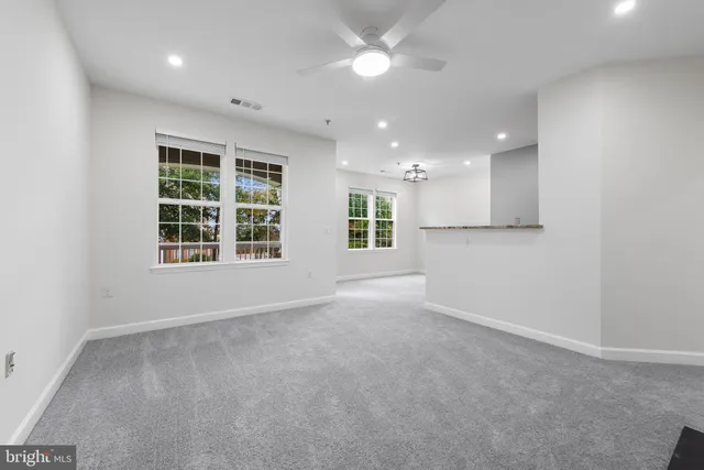 a view of a kitchen with a refrigerator cabinets and a window