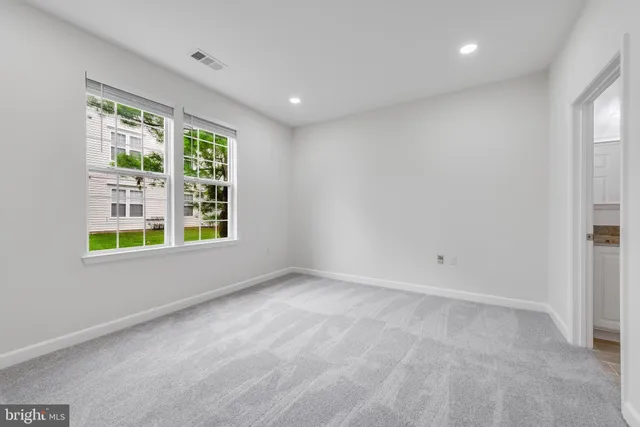 a kitchen with granite countertop wooden cabinets stainless steel appliances and a window