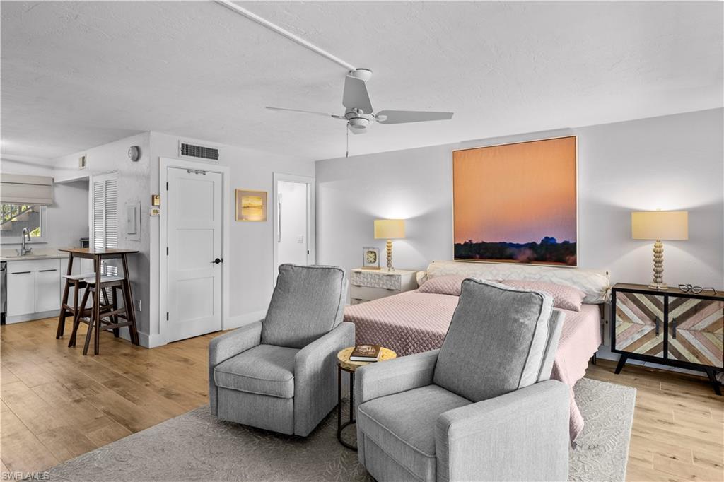 377 Vanderbilt Beach Road, Unit 102 Naples, FL 34108 - Photo 8 of 19 a living room with furniture and a table