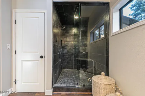 a bathroom with a toilet and a shower
