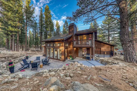 a view of a house with a yard patio and sitting area