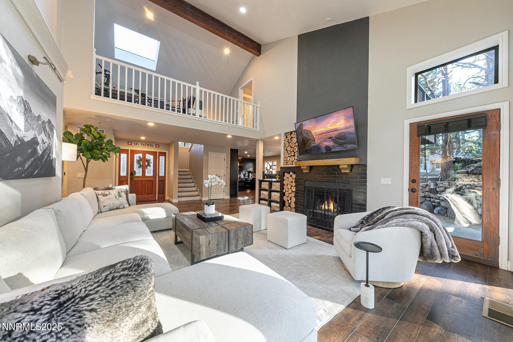 25 Winterberry Court Reno, NV 89511 - Photo 5 of 31 a living room with furniture a fireplace and a large window