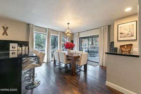 a view of a dining room with furniture large windows and wooden floor