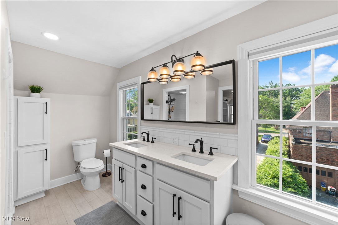 3725 Sutherland Road Shaker Heights, OH 44122 - Photo 21 of 24 Bathroom with backsplash, double vanity, and lofted ceiling
