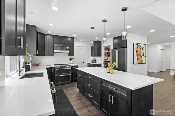 a kitchen with a sink appliances and cabinets