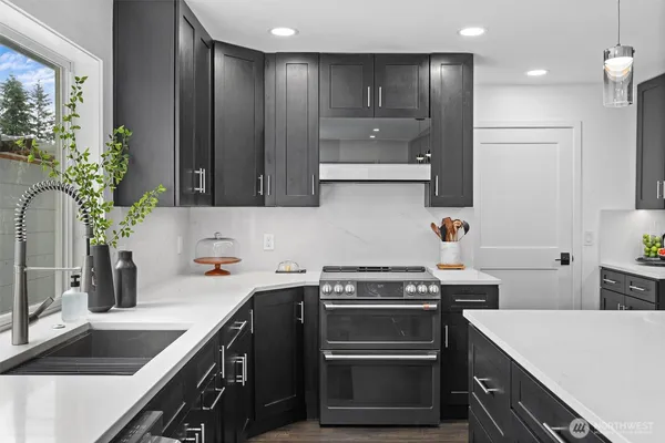 a kitchen with a sink stove and refrigerator