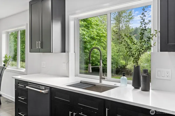 a kitchen with a sink and large window