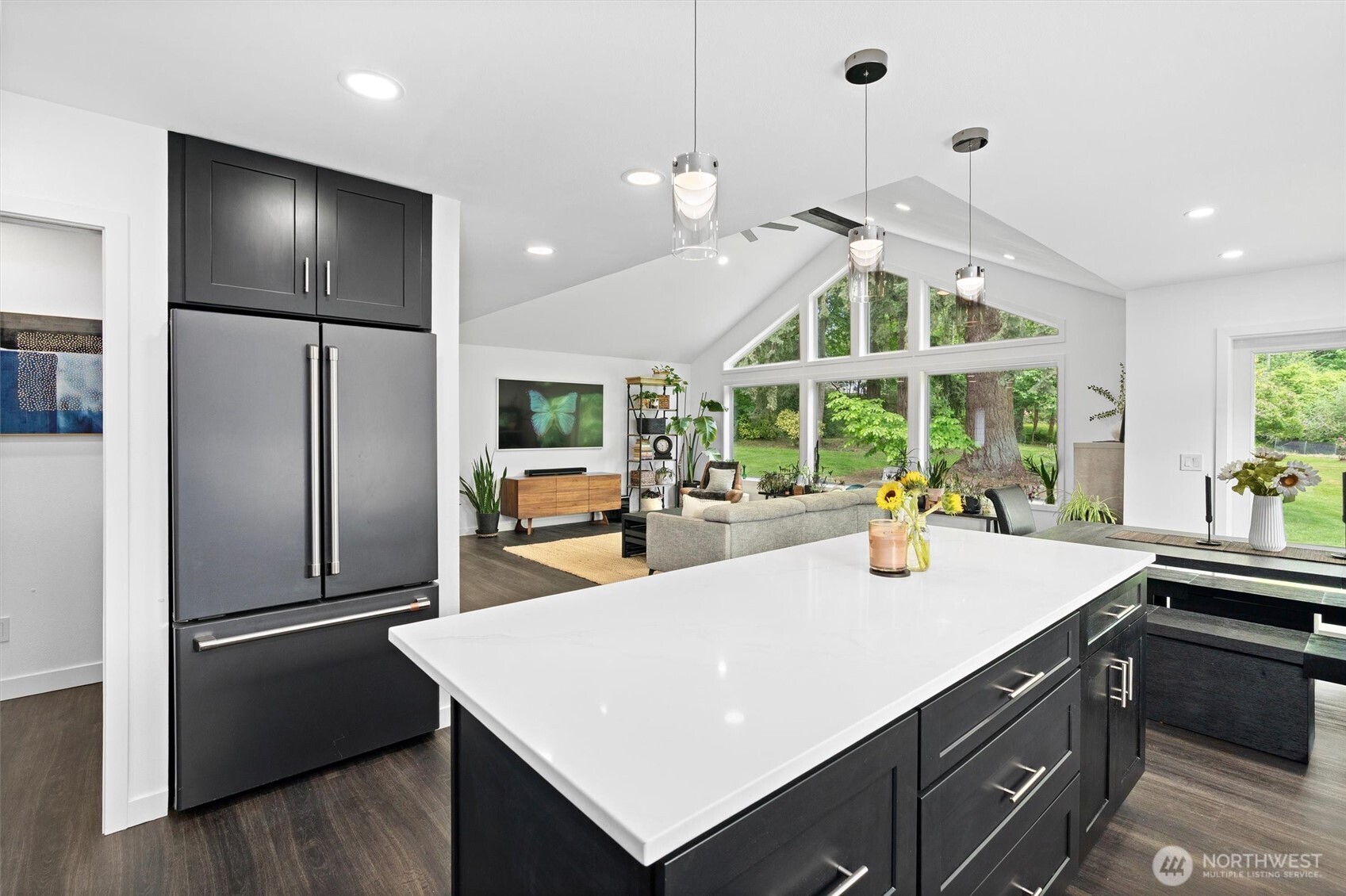 16100 Southeast 113th Place Renton, WA 98059 - Photo 16 of 40 a view of a kitchen with kitchen island a large counter top space stainless steel appliances and a large window