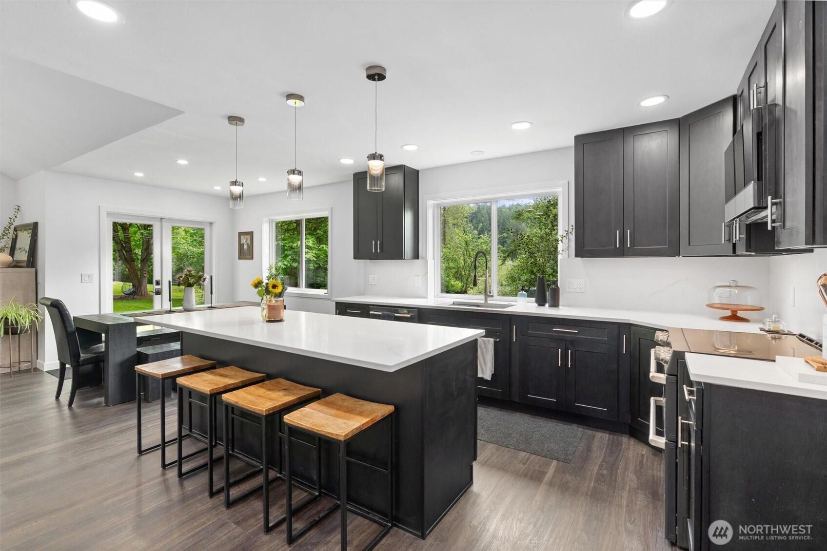 16100 Southeast 113th Place Renton, WA 98059 - Photo 17 of 40 a kitchen with kitchen island granite countertop wooden floors and white appliances