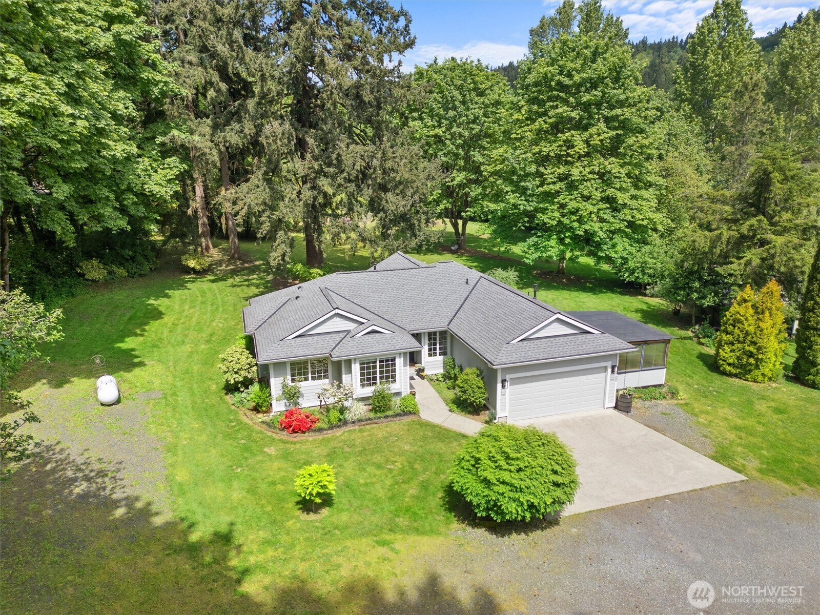 16100 Southeast 113th Place Renton, WA 98059 - Photo 2 of 40 a aerial view of a house with table and chairs under an umbrella