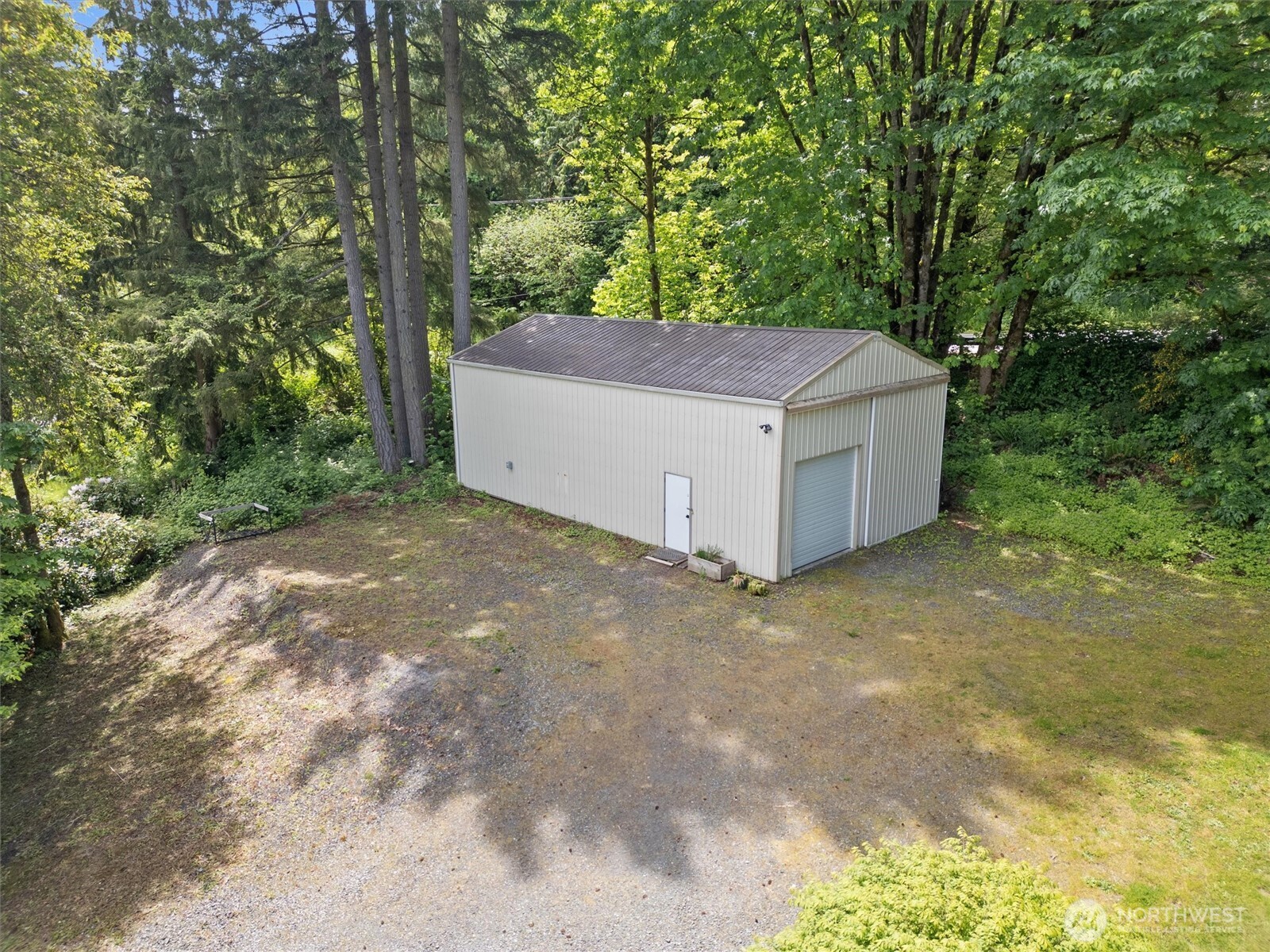 16100 Southeast 113th Place Renton, WA 98059 - Photo 2 of 40 a view of a wooden house with a yard