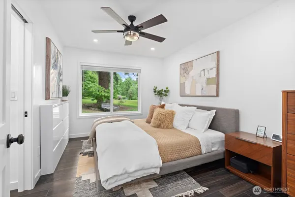 a spacious bedroom with a large bed and a chandelier