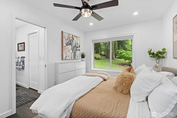 a bedroom with a large bed and a painting on the wall