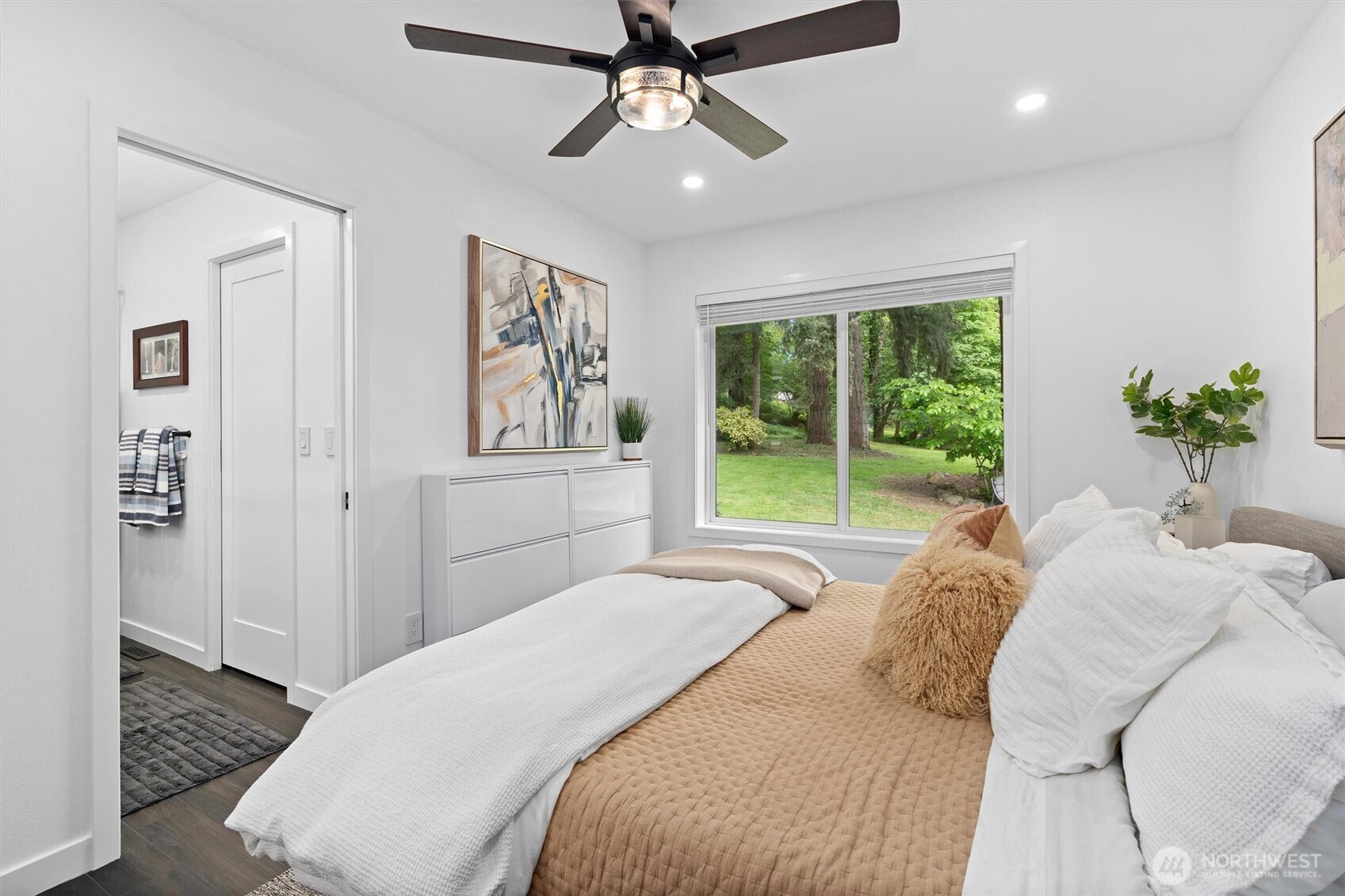 16100 Southeast 113th Place Renton, WA 98059 - Photo 22 of 40 a spacious bedroom with a large bed and a chandelier