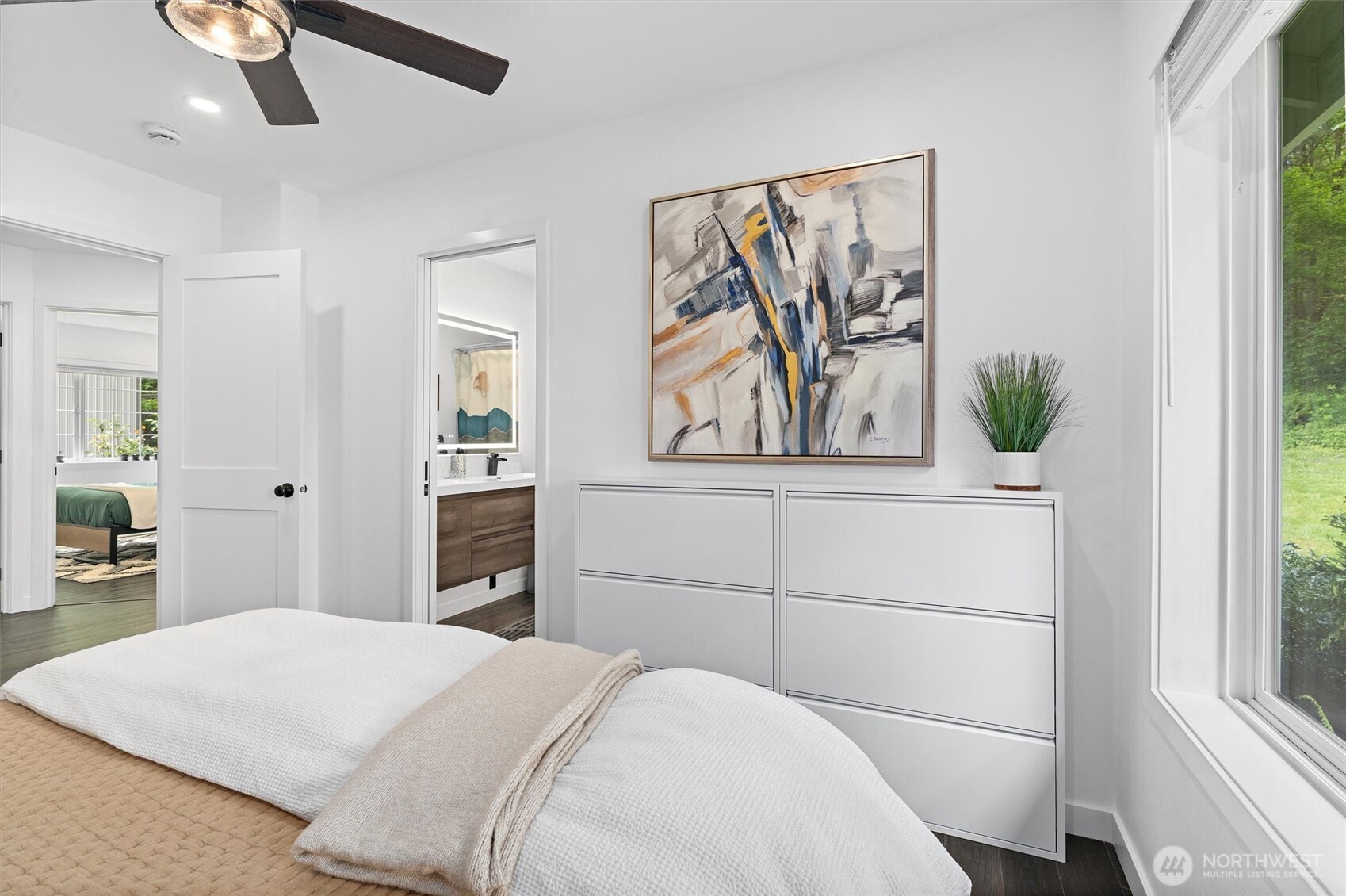 16100 Southeast 113th Place Renton, WA 98059 - Photo 23 of 40 a bedroom with a large bed and a painting on the wall