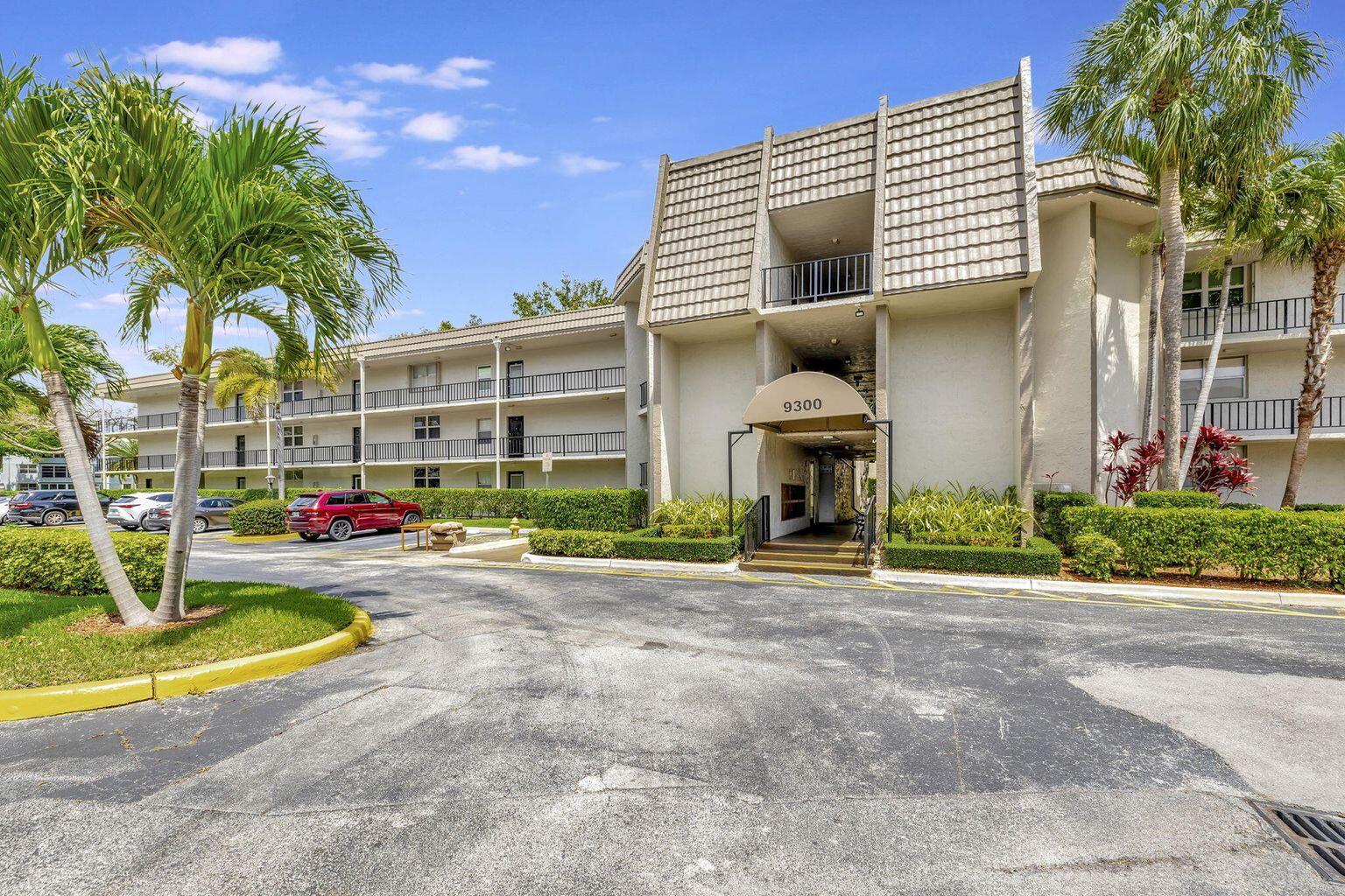 9300 Lime Bay Boulevard, Unit 302 Tamarac, FL 33321 - Photo 1 of 15 a view of multiple houses with a yard