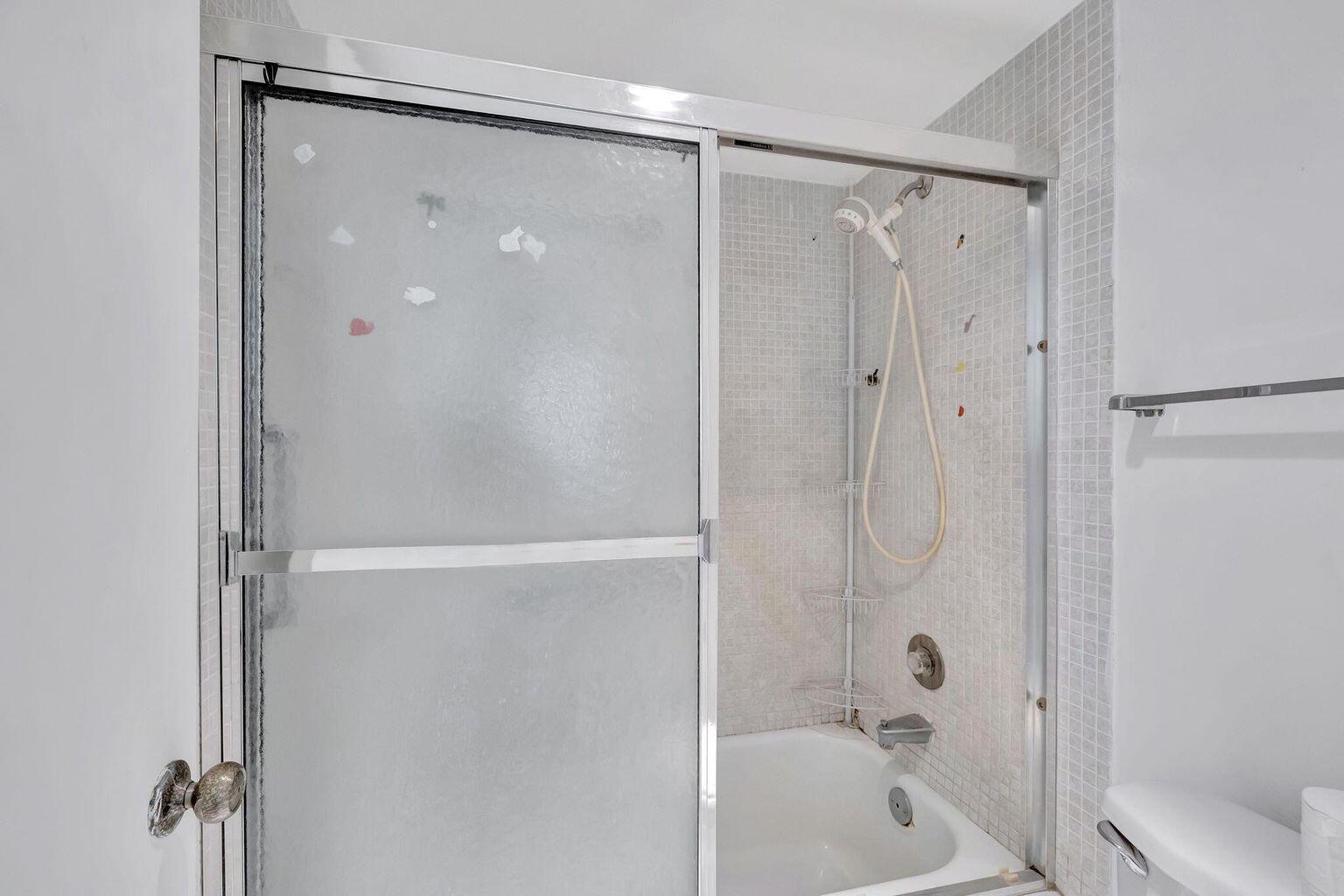 9300 Lime Bay Boulevard, Unit 302 Tamarac, FL 33321 - Photo 12 of 15 a bathroom with a shower and a bath tub