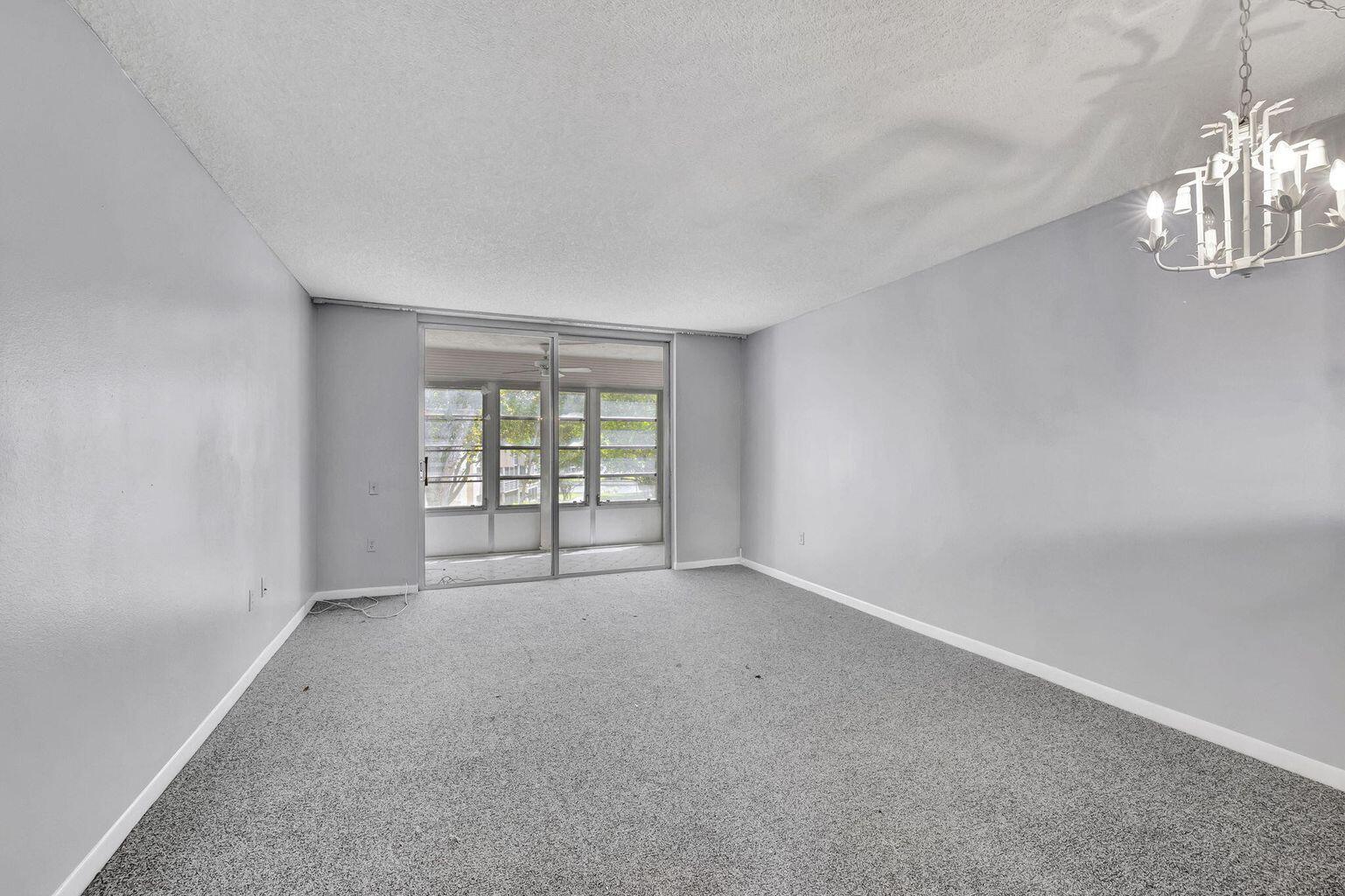 9300 Lime Bay Boulevard, Unit 302 Tamarac, FL 33321 - Photo 6 of 15 a view of an empty room with a window