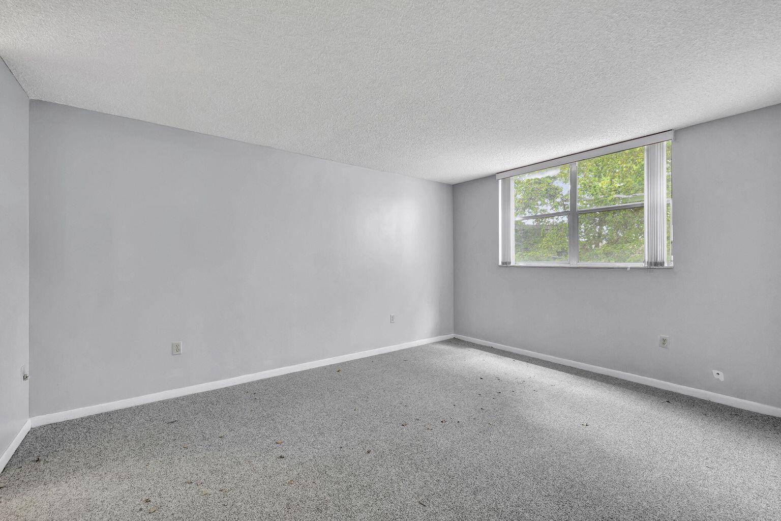 9300 Lime Bay Boulevard, Unit 302 Tamarac, FL 33321 - Photo 9 of 15 a view of an empty room with a window