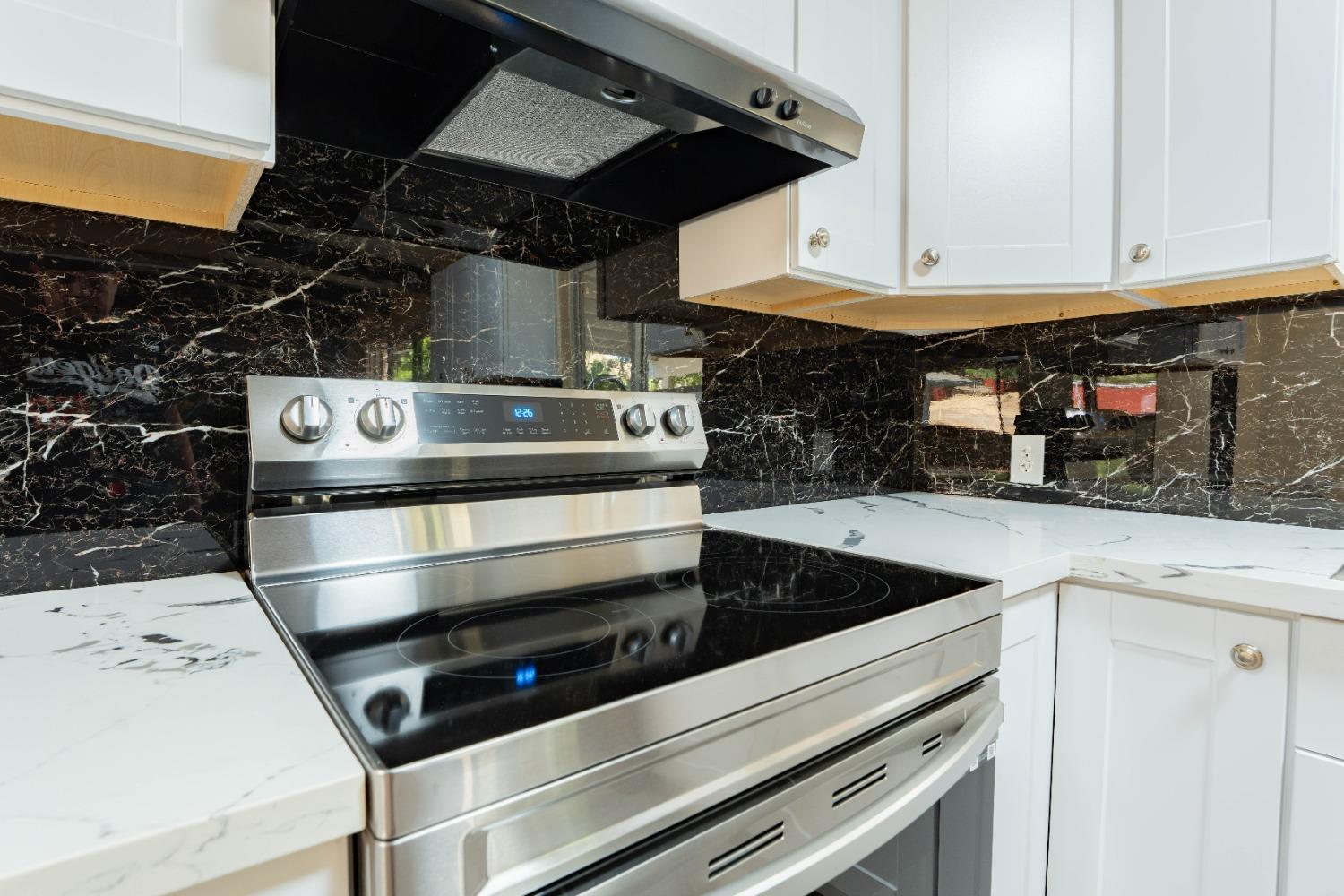 47517 Road 200 O'Neals, CA 93645 - Photo 12 of 54 a kitchen with a stove and white cabinets