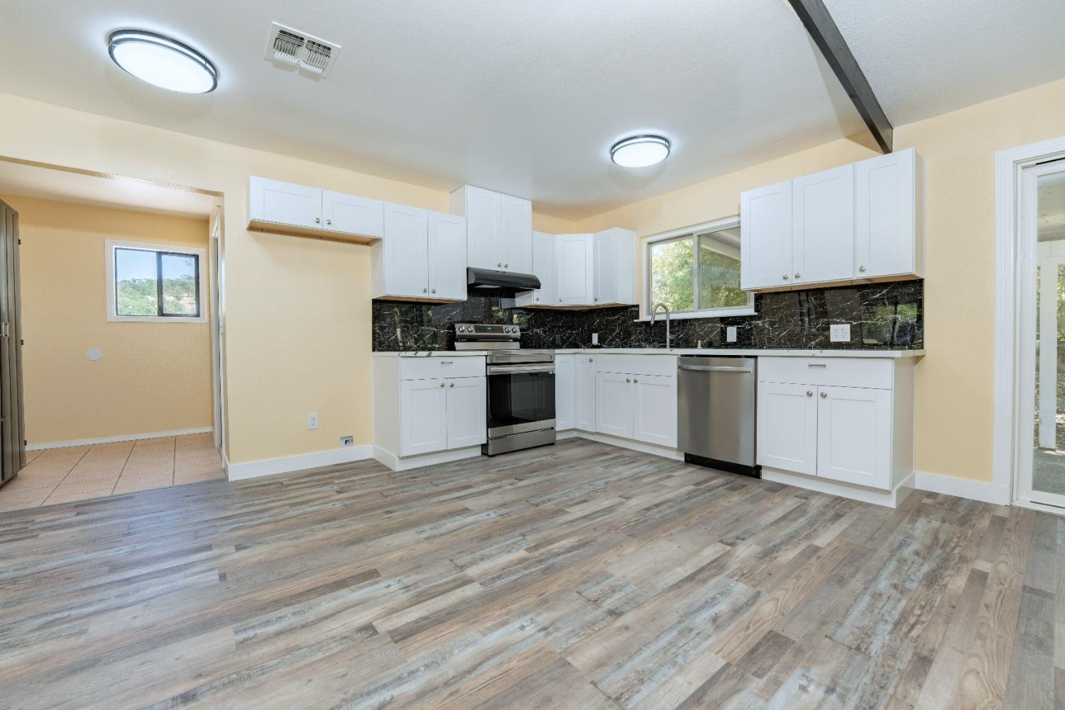 47517 Road 200 O'Neals, CA 93645 - Photo 14 of 54 a kitchen with a sink a stove top oven and white kitchen