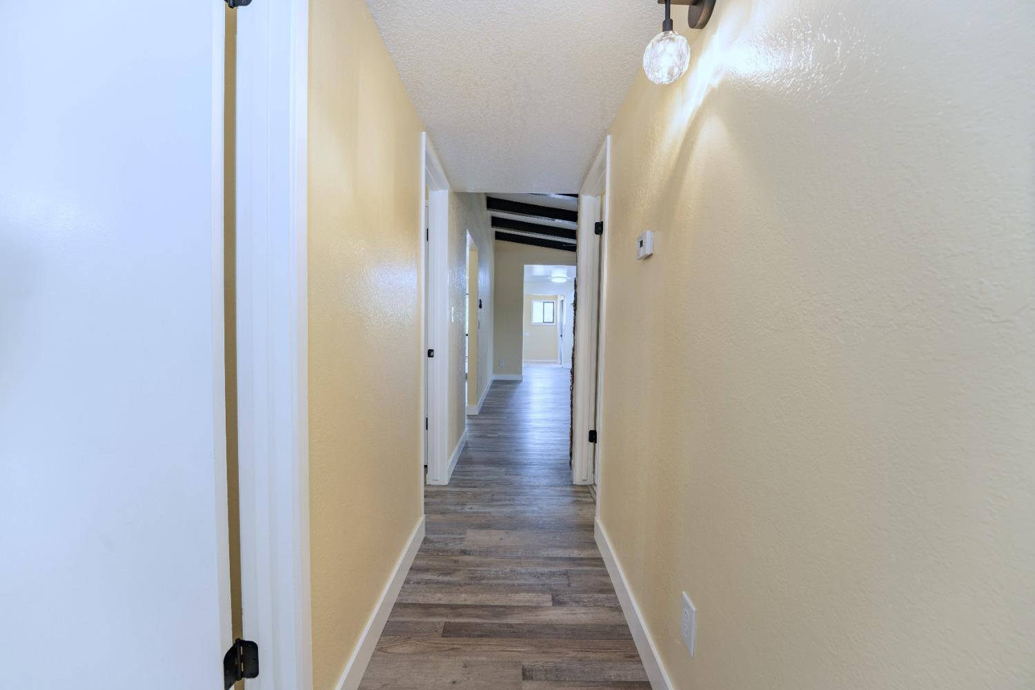 47517 Road 200 O'Neals, CA 93645 - Photo 30 of 54 a view of a hallway with wooden floor and staircase