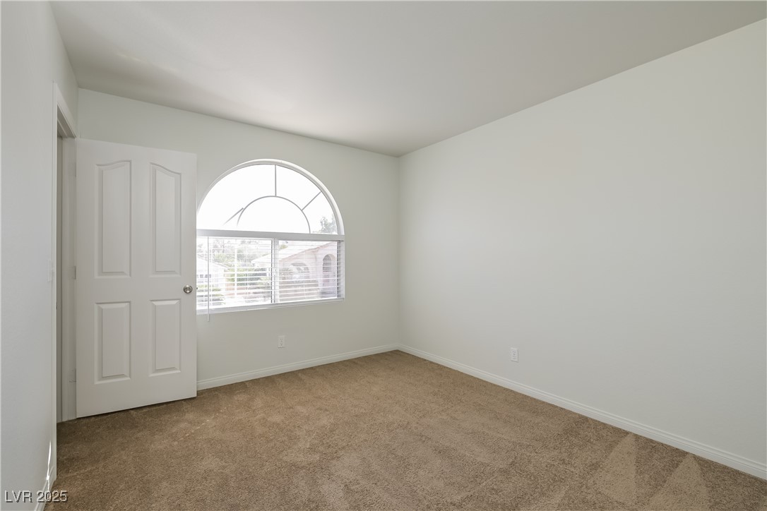 8906 Chapman Point Las Vegas, NV 89129 - Photo 12 of 13 Carpeted spare room with baseboards