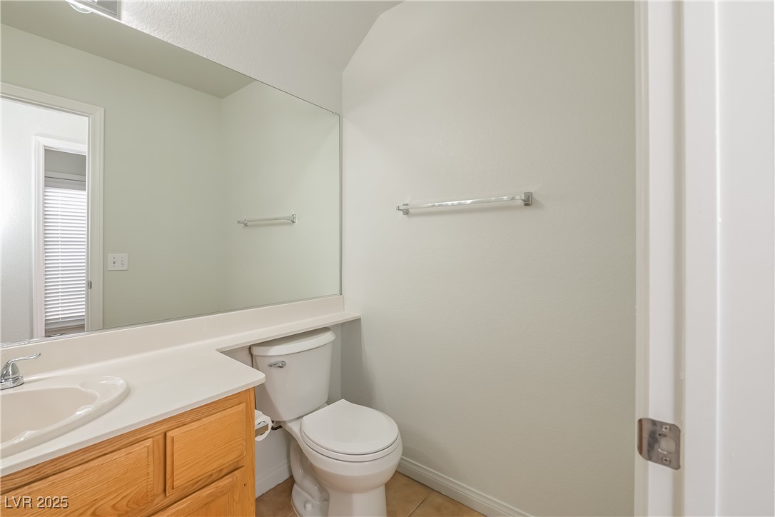 8906 Chapman Point Las Vegas, NV 89129 - Photo 13 of 13 Bathroom featuring vanity and light tile patterned flooring
