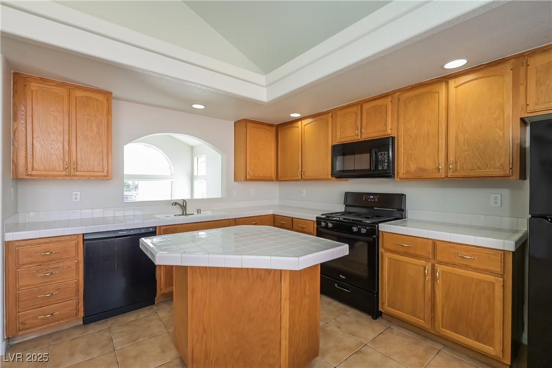 8906 Chapman Point Las Vegas, NV 89129 - Photo 7 of 13 Kitchen with black appliances, recessed lighting, tile countertops, and light tile patterned flooring