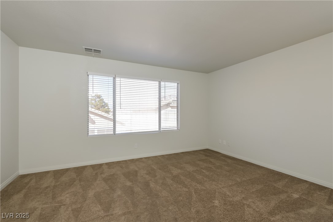 8906 Chapman Point Las Vegas, NV 89129 - Photo 8 of 13 Carpeted empty room featuring baseboards