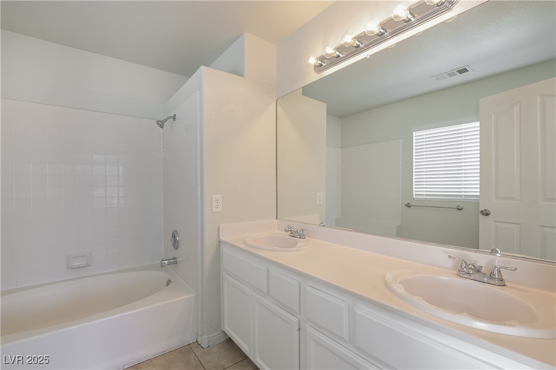 8906 Chapman Point Las Vegas, NV 89129 - Photo 9 of 13 Full bathroom featuring light tile patterned floors, double vanity, and bathtub / shower combination
