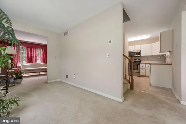 a view of kitchen with refrigerator stove and window
